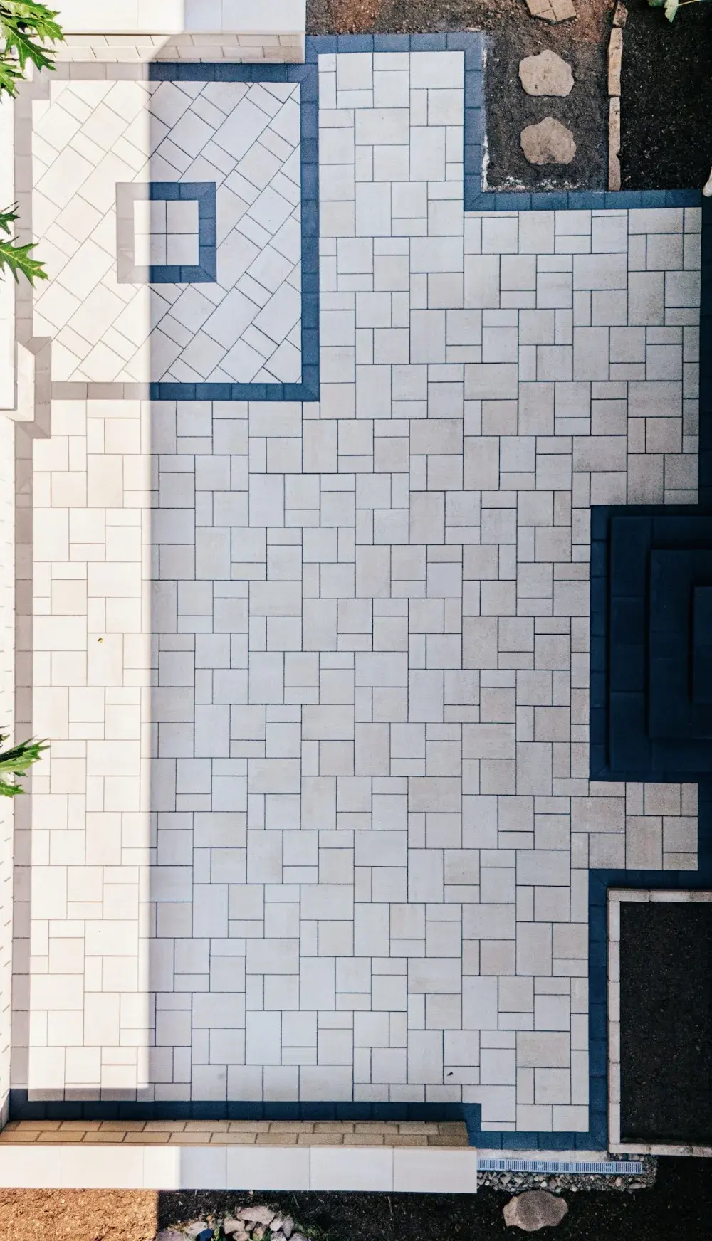 Overhead view of a long paver patio with a contrasting border
