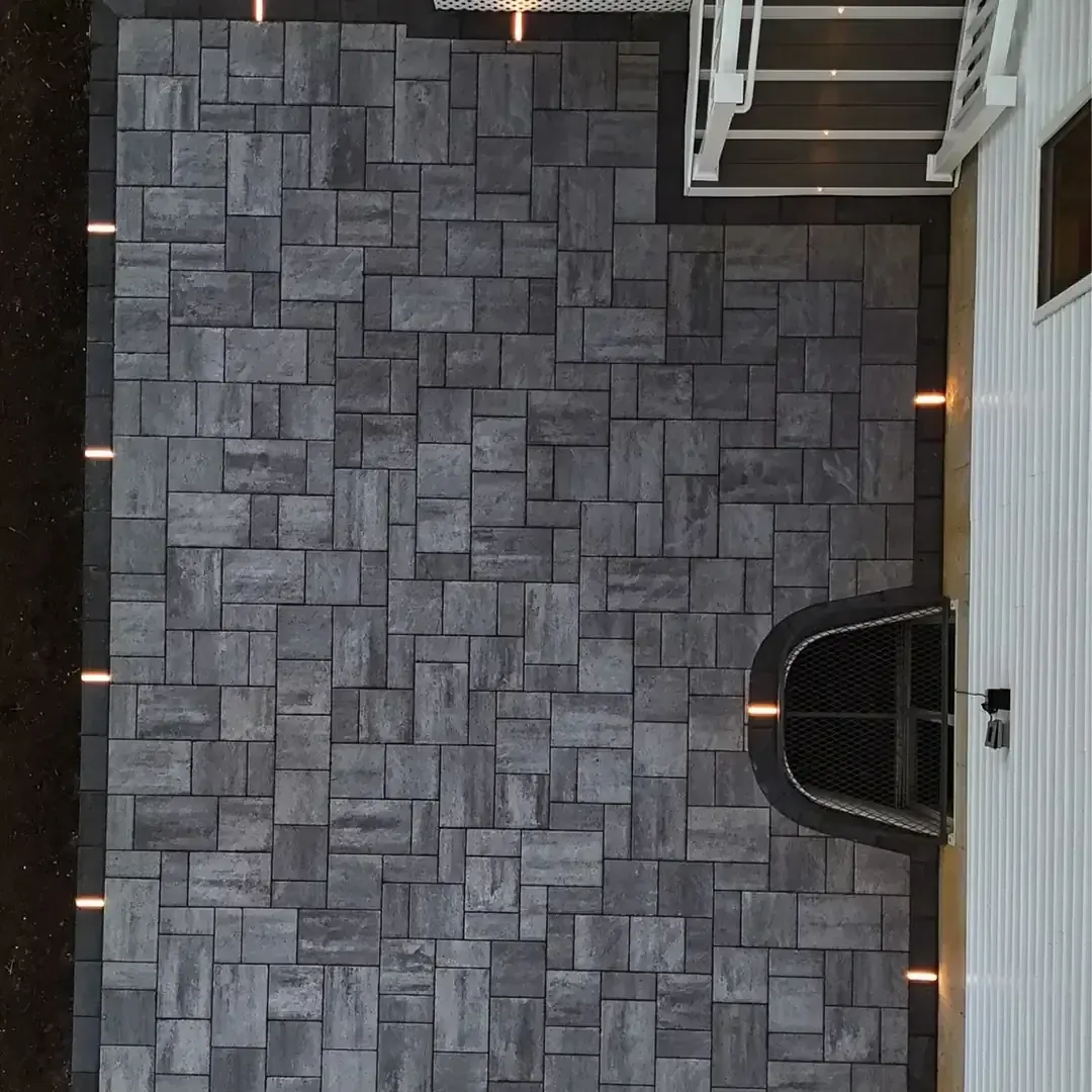 Overhead view of a large paver patio beside a home